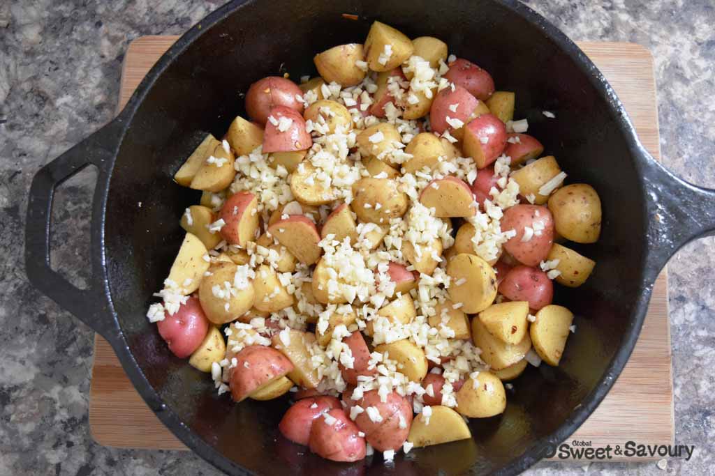 potatoes with garlic in cast iron pan